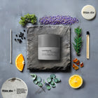 Lavendure 21 scented candle surrounded by natural ingredients including lavender, citrus, eucalyptus, and fir