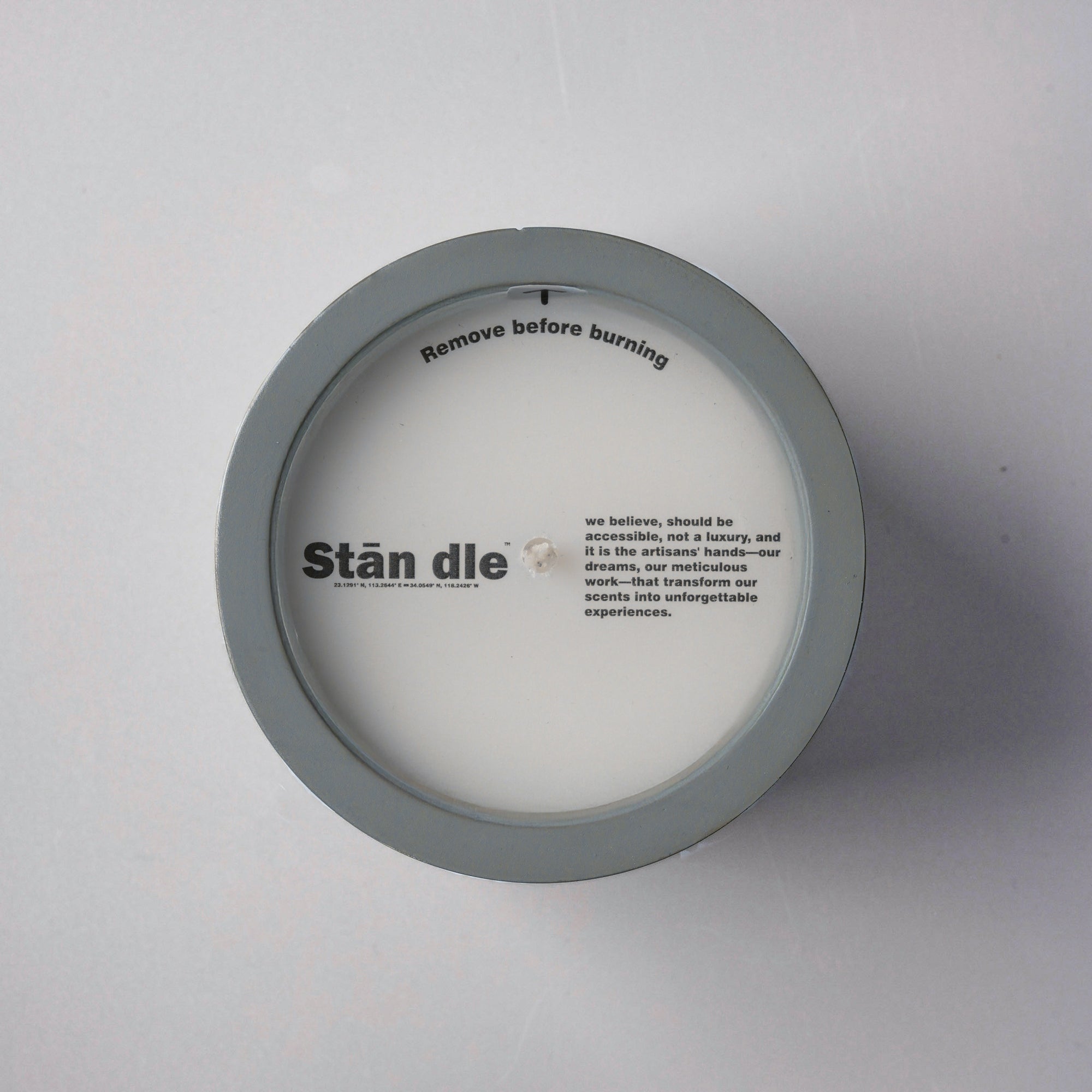 Top view of candle lid with brand logo and artisan-crafted message