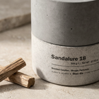 Close-up of Sandalure 18 hand-cast concrete vessel label with sandalwood pieces