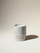 Lavendure 21 lavender and eucalyptus candle — 300g soy wax in a two-tone hand-cast concrete vessel, unlit, on a warm off-white studio backdrop