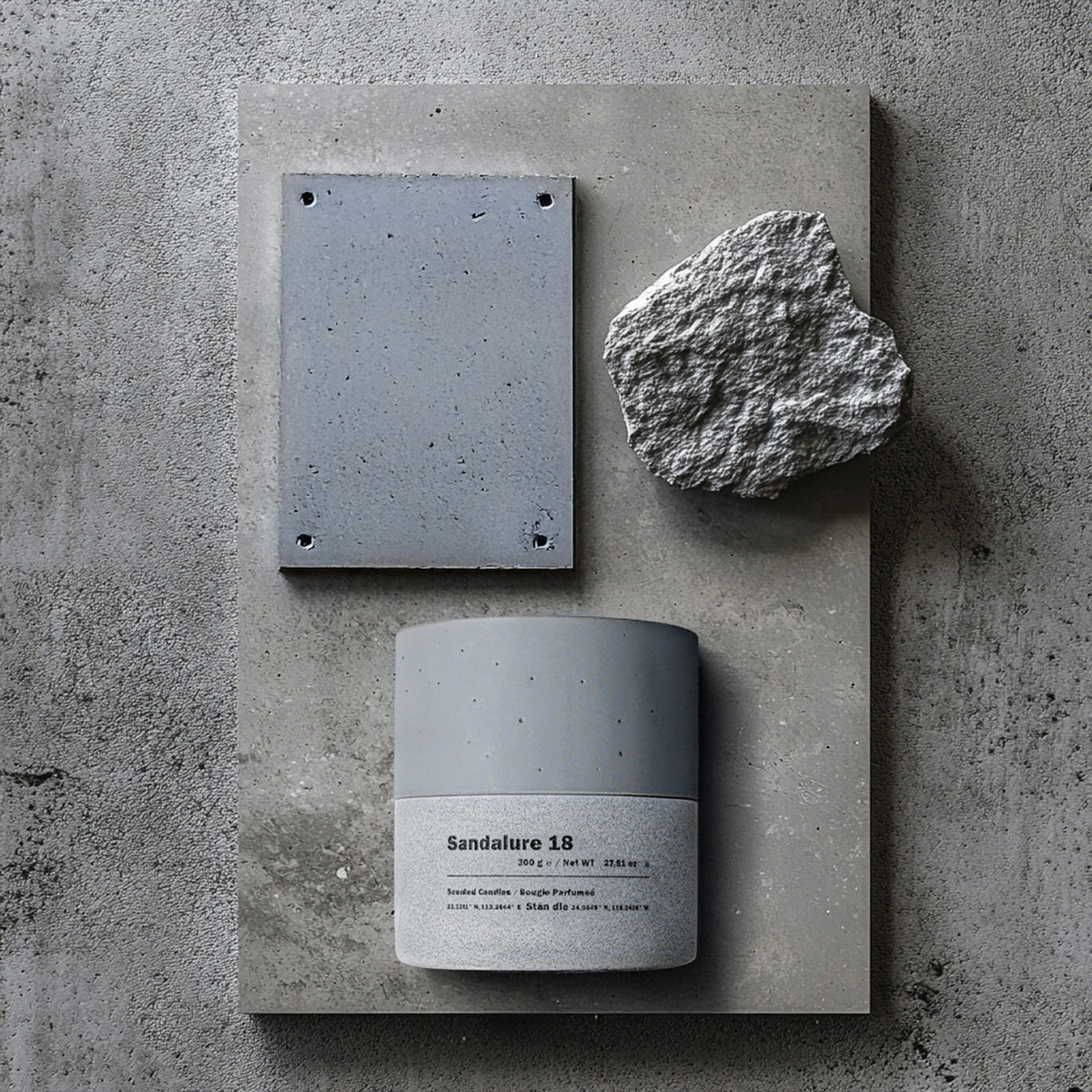 Sandalure 18 Vanilla Scented Candle in a sleek concrete vessel with raw concrete and stone elements